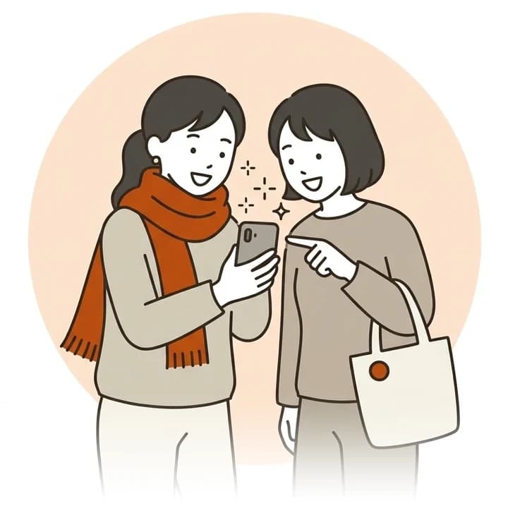 スマホの画面を見せ合い、「これ使いたい!」と盛り上がる2人のイラスト